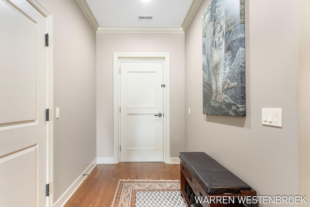 doorway featuring ornamental molding and hardwood / wood-style floors