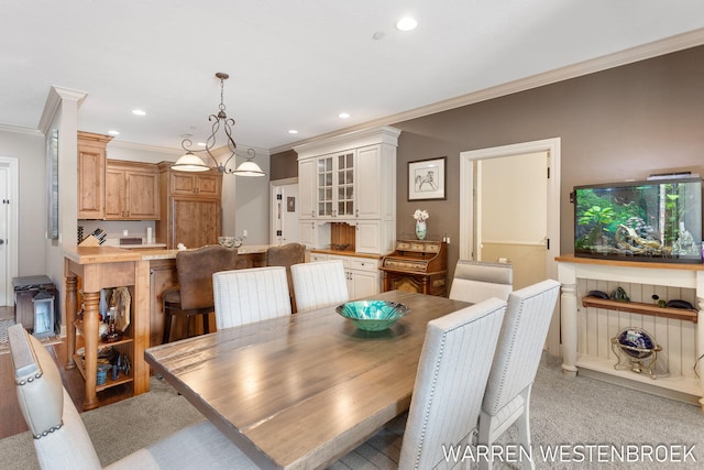 dining area featuring ornamental molding and light carpet