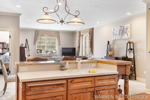 kitchen featuring light colored carpet, hanging light fixtures, and ornamental molding