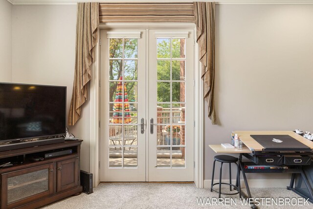 entryway with light colored carpet and french doors