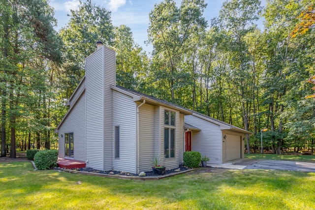 view of side of property featuring a yard and a garage