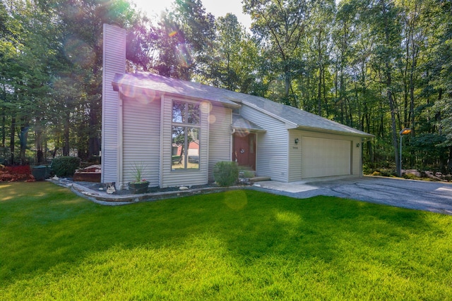 ranch-style house featuring a garage and a front lawn