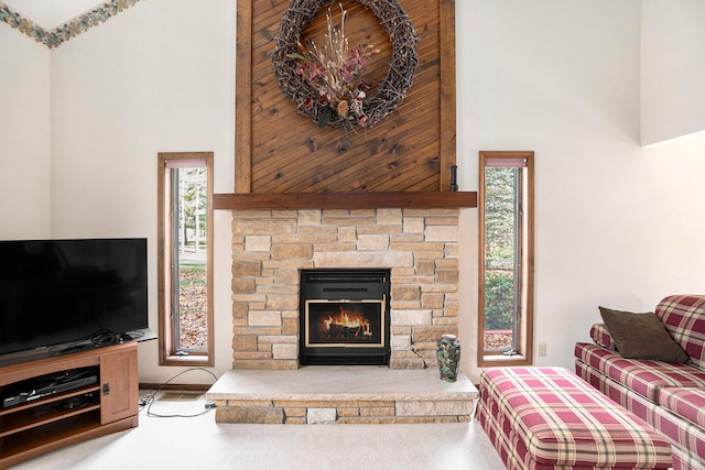 living room featuring a fireplace and a high ceiling