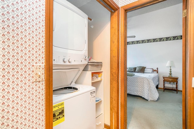 laundry room with stacked washer and dryer, carpet floors, and a textured ceiling