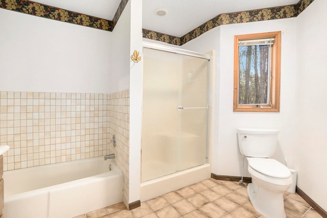 bathroom with tile patterned flooring, toilet, and a textured ceiling