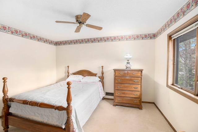 carpeted bedroom featuring multiple windows and ceiling fan