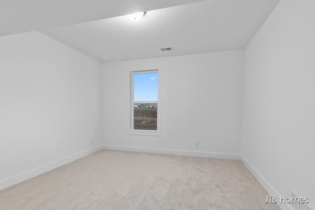 unfurnished room featuring light carpet