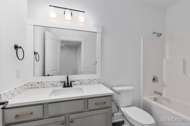 full bathroom featuring washtub / shower combination, vanity, and toilet