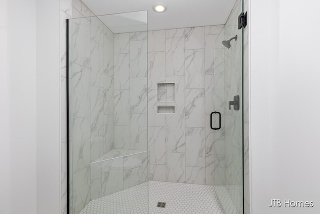 bathroom with a shower with shower door