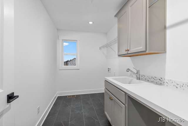 clothes washing area with cabinets, sink, and hookup for a washing machine