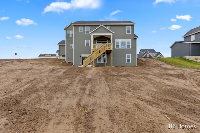 back of property with a wooden deck