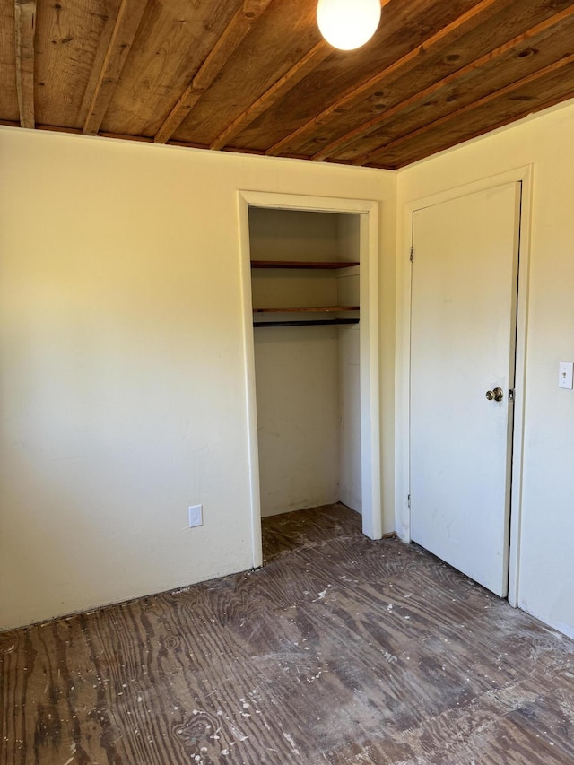 unfurnished bedroom with a closet and wood ceiling