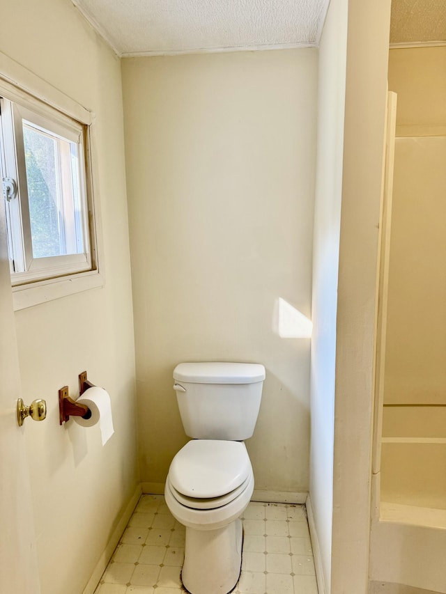 bathroom with a textured ceiling and toilet