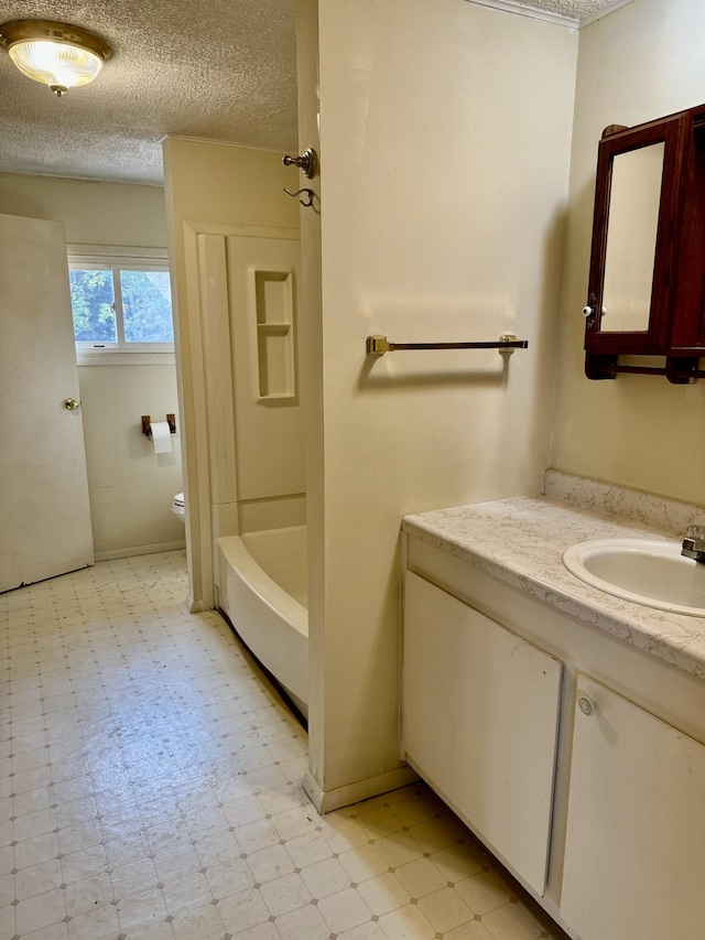 full bathroom with shower / bathing tub combination, vanity, a textured ceiling, and toilet