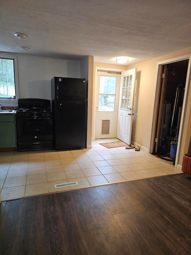 foyer featuring sink and light wood-type flooring