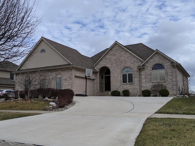 french country style house with a garage and a front lawn