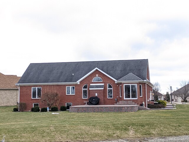 rear view of house featuring a yard and a patio area