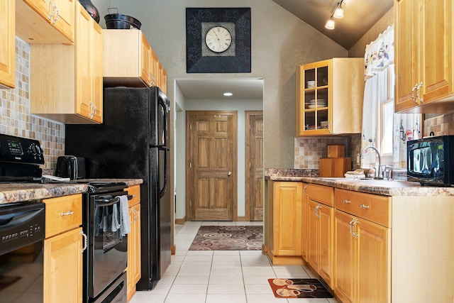 kitchen featuring black appliances, sink, backsplash, and light tile patterned flooring