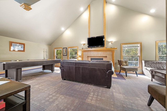 interior space with pool table, high vaulted ceiling, a tile fireplace, and carpet floors