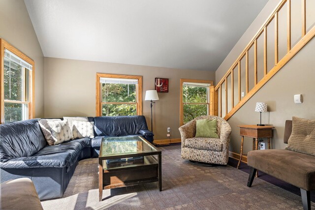 carpeted living room with lofted ceiling