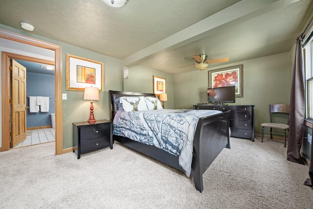 carpeted bedroom featuring a textured ceiling and ceiling fan