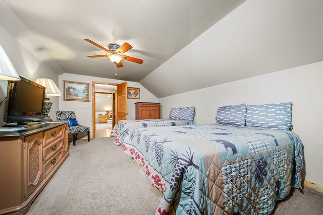 carpeted bedroom featuring lofted ceiling and ceiling fan