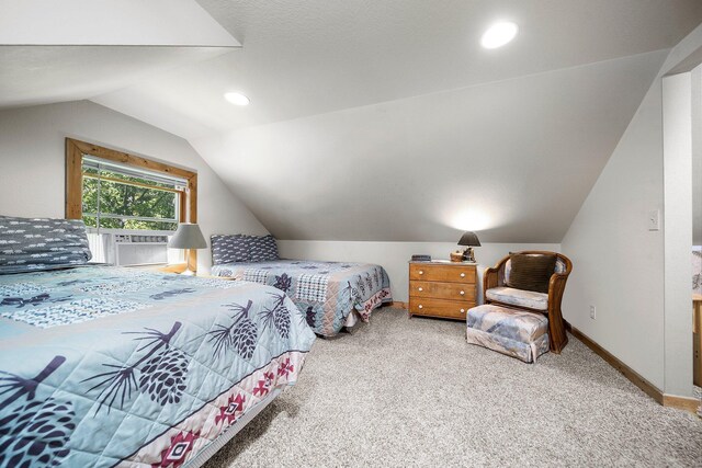 carpeted bedroom with lofted ceiling and cooling unit