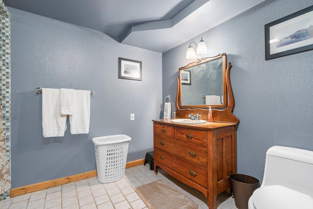 bathroom featuring tile patterned floors, toilet, and vanity