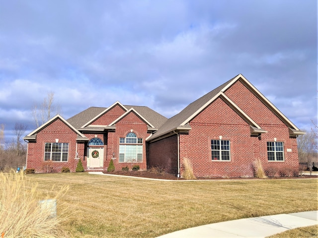 8187 Hunters Ridge Dr, Newport, MI 48166 - view of front facade featuring brick siding, a front lawn, and roof with shingles