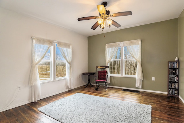 unfurnished room with ceiling fan, plenty of natural light, and dark hardwood / wood-style floors