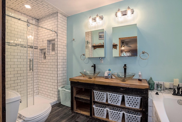 full bathroom with plus walk in shower, wood-type flooring, vanity, and toilet