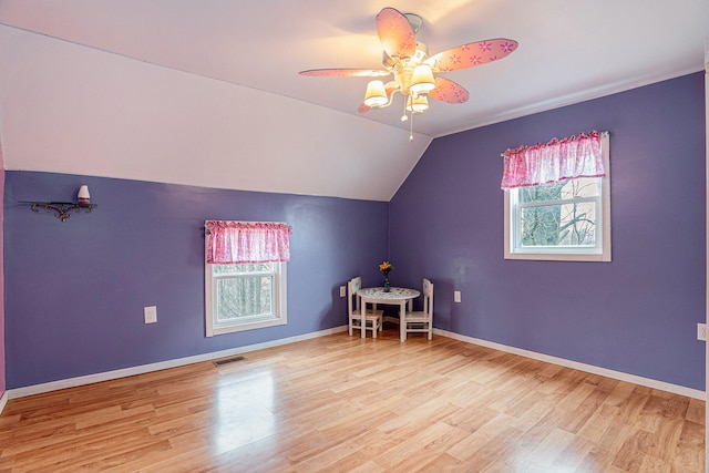 additional living space featuring light wood-type flooring, lofted ceiling, and ceiling fan