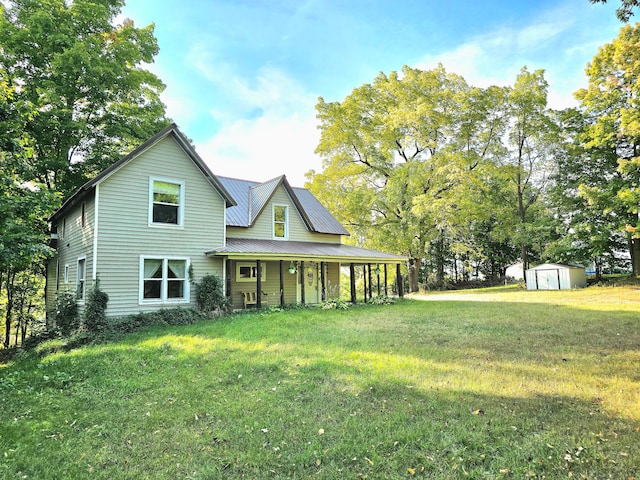 view of front of home with a front yard and a shed