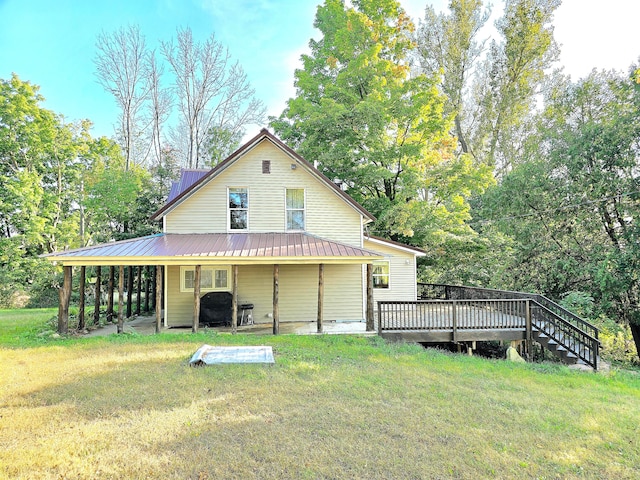 back of house with a lawn