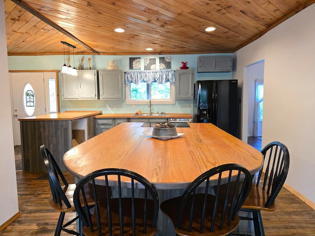 kitchen with wood ceiling, a wealth of natural light, dark wood-type flooring, and black refrigerator with ice dispenser