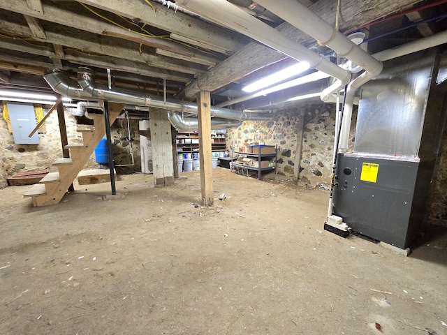 basement with electric panel and heating unit