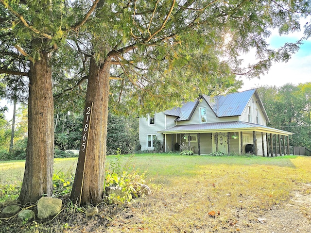 view of front of home with covered porch and a front yard