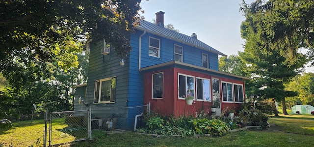 view of side of property with a lawn