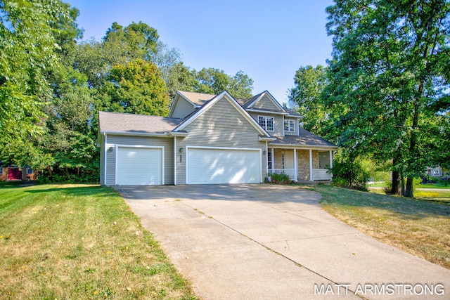 view of front property featuring covered porch, a garage, and a front lawn