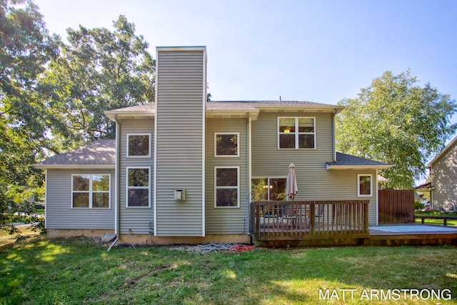 back of property with a wooden deck and a yard