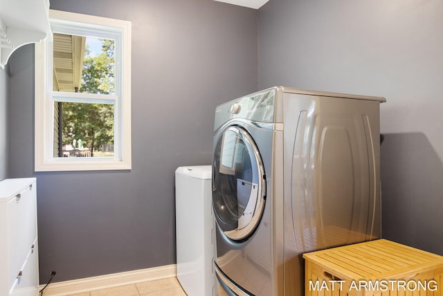 laundry room featuring light tile patterned floors and washer and dryer