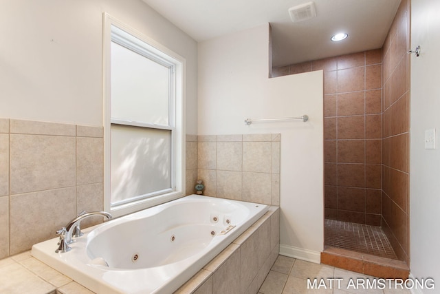 bathroom with tile patterned flooring and separate shower and tub