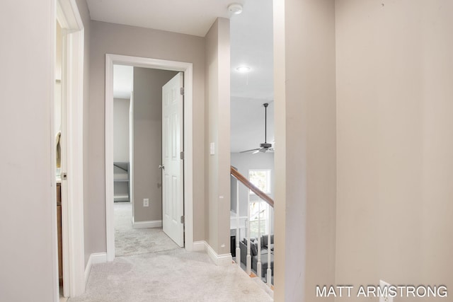 hallway featuring light colored carpet