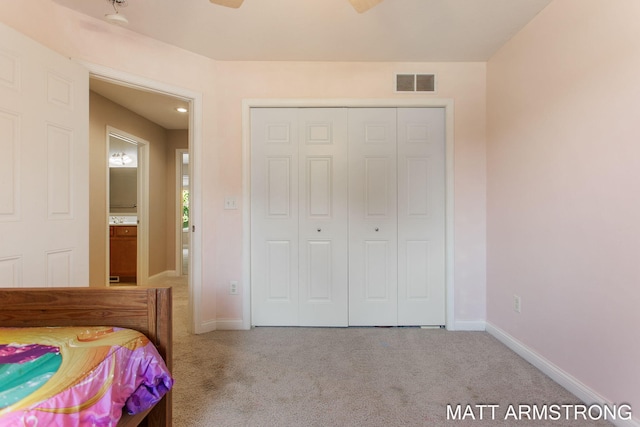 carpeted bedroom featuring ceiling fan and a closet