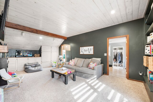 carpeted living room with lofted ceiling with beams