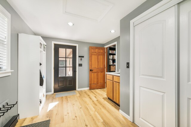 foyer entrance with light hardwood / wood-style flooring