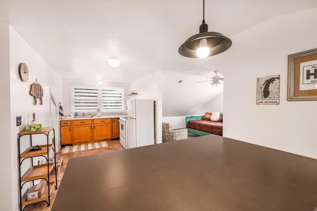 dining room featuring ceiling fan, sink, and vaulted ceiling