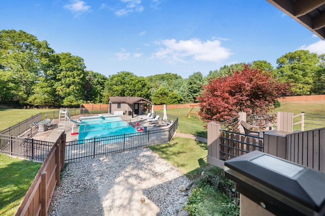 view of pool featuring a yard, a water slide, and a patio area