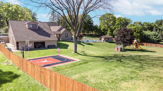 view of yard featuring a storage shed, basketball court, and a playground