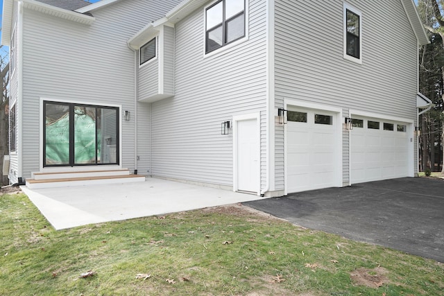 view of home's exterior with a yard and a garage